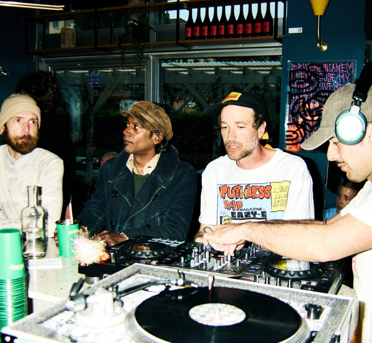 A DJ booth with people around.